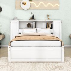 a white bed sitting next to a book shelf on top of a carpeted floor