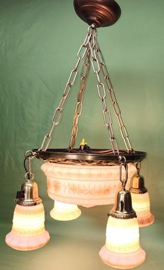 three light fixtures hanging from a chandelier