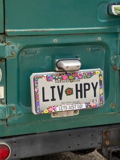 a license plate on the back of a green truck that says livv - hipy