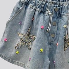 Introducing the 2023 Summer Collection the perfect balance between vintage nostalgia and trendy flair. Our Rhinestone Star Embellished Denim Shorts. Y2K Style will bring you back to the era of innocence and fun. Featuring a high-waist. baggy fit. rhinestone stars. buttons. and rubber closure. these shorts will make you feel like you've stepped into a time machine!Why These Shorts Will Make You Feel Like a Kid Again A Blast from the Past: Step back in time with the vintage Y2K style. featuring a Summer Star Print Denim Jeans, Cotton Jeans With Star Patch For Summer, Denim Blue Summer Bottoms With Star Print, Summer Denim Blue Star Print Bottoms, Trendy Cotton Jean Shorts With Star Print, Trendy Bottoms With Star Patch For Spring, Trendy Spring Bottoms With Star Patch, Summer Denim Shorts With Star Print, Trendy Summer Jean Shorts With Star Print