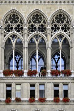 an ornate building with many windows and flower boxes