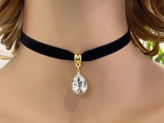 "Black velvet choker with Swarovski Crystal pear shaped stones in Emerald  pendent. The necklace is 10mm wide in black velvet color. the total length of the black band is 12\"  and there is 2\" silver plated extension chain.  with the clasp and 2 jump rings  on both sides , the necklace will close at 12 1/2\" as a shortest length.  18x13mm Swarovski Crystal pear shaped stones in Emerald  attached using a silver plated jump ring to a smooth cup big hole bead bail . you can choose the length that Elegant Adjustable Teardrop Choker, Pendent Necklace Gold, Choker Gold Necklace, Black Velvet Ribbon, Ribbon Choker, Black Velvet Choker, Choker Gold, Ribbon Necklace, Velvet Choker