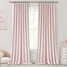 the pink curtains in this room are ready to be hung