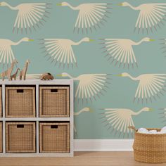 the wallpaper in this room is painted with white birds and beige wicker baskets