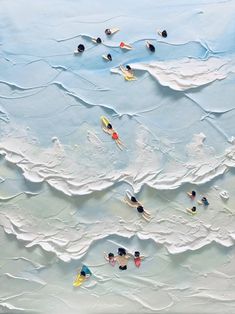 an aerial view of people swimming in the ocean with surfboards on their backs and feet