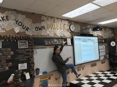 a woman standing in front of a whiteboard with writing on it and pointing to the side