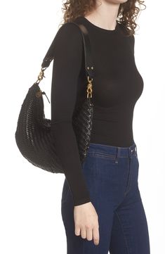 Style this woven leather statement as a shoulder bag or a crossbody thanks to its adjustable strap that connects with goldtone hardware on each end. Leather/cotton Imported Latinx Owned and Founded Woven Leather Crossbody Bucket Bag For On-the-go, Black Woven Leather Hobo Bag For On-the-go, Luxury Woven Leather Shoulder Bag For On-the-go, Black Woven Leather Shoulder Bag For On-the-go, Luxury Intrecciato Weave Crossbody Bucket Bag, Luxury Hobo Bag With Braided Handles For On-the-go, Black Woven Hobo Bag With Top Handle, Evening Woven Leather Crossbody Bucket Bag, Modern Crossbody Shoulder Bag With Intrecciato Weave