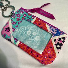 Nwt - Brand New Vera Bradley Lanyard Wallet. *Item Comes From A Smoke-Free Home. Multicolor Rectangular Card Holder For Travel, Purple Rectangular Bag With Card Slots, Purple Travel Wallet Pouch, Purple Travel Pouch Wallet, Purple Pouch Wallet For Travel, Multicolor Rectangular Card Holder For Daily Use, Multicolor Rectangular Card Holder For Personal Use, Multicolor Rectangular Coin Purse With Key Chain Holder, Multicolor Rectangular Coin Purse With Interior Key Chain Holder