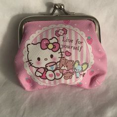 a hello kitty purse is shown on a white sheet