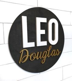 a black and gold sign that says leo dougias