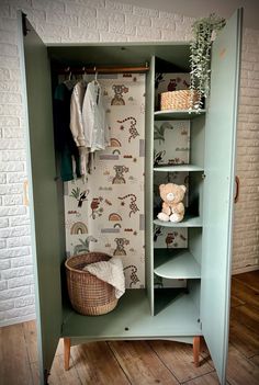 a green cabinet with some stuffed animals on it and a wallpapered background behind it