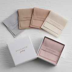 four packagings for panachen are shown in three different colors, one is white and the other is pink