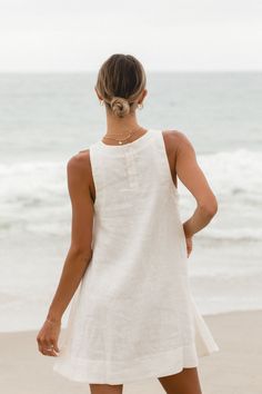 Elevate your wardrobe with the Toulouse Linen Mini Baby Doll. This classic high neck tank dress, made from linen, offers an elevated, timeless look. Luxuriously soft and breathable, this babydoll dress will keep you comfortable and chic. Linen Solid Color Dress For Day Out, White Linen Mini Dress For Daywear, Linen A-line Mini Dress For Beach, Vacation Linen Dress Solid Color, White Linen A-line Mini Dress, Solid Color Linen Vacation Dress, Sleeveless Linen Mini Dress For Daywear, White Linen Sleeveless Dress For Daywear, Sleeveless Linen Dress In Solid Color