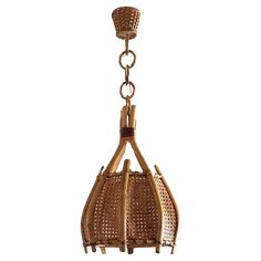 a rattan chandelier hanging from a chain on an isolated white background with clippings