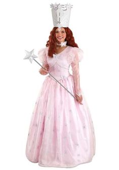 a woman in a pink dress and crown holding a wand with stars on her head