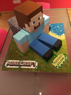 a cake made to look like a minecraft character sitting on top of a table