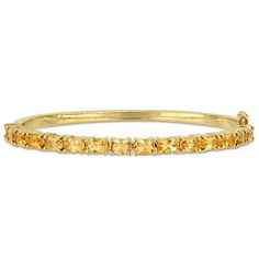 Polish off any attire with this simply stunning gemstone bangle bracelet. Crafted in sterling silver with yellow rhodium plate, this beautiful style showcases a row of 6.0 x 4.0mm oval-shaped golden yellow citrines. Buffed to a brilliant luster, this bracelet measures 7.0 inches in circumference and secures with a tongue and groove clasp. Gemstone Bangle Bracelets, Gemstone Bangle, Sterling Silver Bangle Bracelets, Peoples Jewellers, Citrine Stone, Tongue And Groove, Silver Bangle Bracelets, Beautiful Style, Gold Plated Bracelets