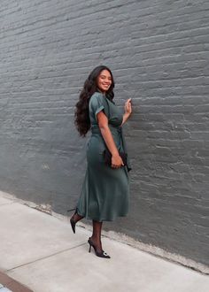 PRODUCT DETAILS: Satin midi dress in dark green Short sleeve Waist tie Functional buttons True to size Minimal stretch Length: 55" 95% Polyester, 5% Spandex Model is wearing a size Medium Model Info: Height: 5'6", Bust: 41", Waist: 34, Hips: 41" Satin Midi Dress, Green Shorts, Waist Tie, Dark Green, Midi Dress, Size Medium, Spandex, Satin, Green