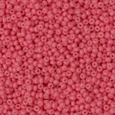 pink beads are shown close up on a white surface