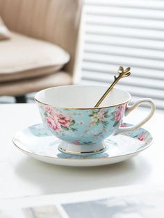 a tea cup and saucer sitting on top of a table