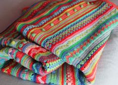 multicolored crocheted blanket folded on top of each other