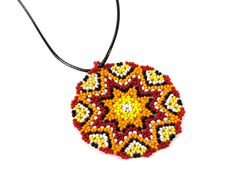 Huichol necklace is handmade from seed beads in Native american style. The size of huichol necklace is 2.4 inches (6 cm). Huichol necklace comes with a cord. Cord has adjustable chain its length - 17.3" - 19.3" (44 cm - max 49 cm). 100% handmade. Made of High Quality Czech beads PACKAGING: Arrives in a white jewelry gift box - ready to be given as a gift. OTHER VARIATIONS Blue mandala pendant - https://www.etsy.com/listing/641699546/mandala-necklace-hippie-pendant-seed?ref=shop_home_active_20 Gr Red Pendant Beaded Necklace For Festivals, Red Amulet Beaded Necklaces With Colorful Beads, Red Artisan Beaded Necklaces For Crafting, Artisan Red Beaded Necklaces For Crafting, Medallion Beaded Necklace As Gift, Handmade Multicolor Beaded Medallion Necklaces, Handmade Multicolor Medallion Beaded Necklaces, Multicolor Handmade Medallion Beaded Necklaces, Handmade Multicolor Medallion Beaded Necklace