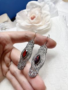 Red Garnet Cubic Zirconia Earrings Iris Design#E2 Custom Made Re-fashioned from an Art Deco pin from the 1920's, I now offer these lovely Antique reproduction earrings in sterling silver. Each stunning bezel set 2.78ct Red Garnet Cubic Zirconia gemstone is 14mm long by 7mm wide. The earrings are 2 1/2 inches long by 11/16th (17mm) wide. Notice the intricate design of the Art Deco filigree setting. A gift box is included and all items are shipped in the box for safe keeping. Feel free to ask ques Ornate Red Drop Earrings, Ornate Red Earrings For Party, Red Filigree Dangle Earrings, Red Filigree Vintage Jewelry, Red Ruby Earrings With Intricate Design, Ornate Red Filigree Earrings, Ornate Red Earrings For Formal Occasions, Red Victorian Jewelry For Evening, Red Filigree Drop Earrings