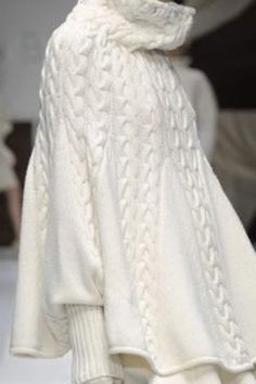 a white sweater with a cowl neck is shown on the catwalk at london fashion week