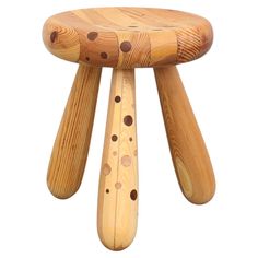 a wooden stool with holes on it