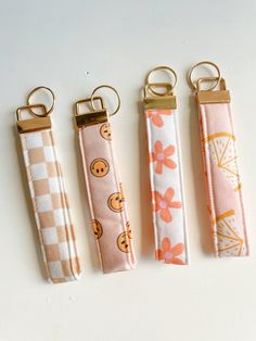 four keychains with different designs on them