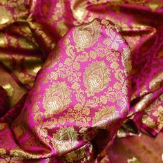 Magenta Wedding Dress Fabric Brocade by the Yard Indian Brocade Jacquard Banarsi Saree Crafting Sewing Costume Pillow Cover Home Décor Skirt. Tanchoi Banarsi Brocade Fabric. This is a beautiful brocade floral design fabric in colors Red, Pink and gold. ➤ Fabric Type: Blended Silk (Viscose & Silk Satin) ➤ Color: Magenta, Pink, Green and Gold ➤ Code: bg2482 ➤ Width of the fabric is 43 inches. ➤ Listing for 1 Yard of fabric.  ➤ Care: Dry Clean Only You can use this fabric to make Dresses, Tops, Blouses, Jackets, Crafting, Clutches or Evening Bags, embellish your clothes, Pillows, Drapery, Home Décor, Outdoor, Quilting, Sewing, General, Upholstery etc. use it for scrap booking projects. Tanchoi is one of the weaving techniques involving a single or double warp and two to five colors on the wef Magenta Wedding Dress, Magenta Wedding, Pink Brocade, Bridal Anklet, Jacquard Saree, Banarasi Brocade, Wedding Dress Fabric, Banarsi Saree, Color Magenta