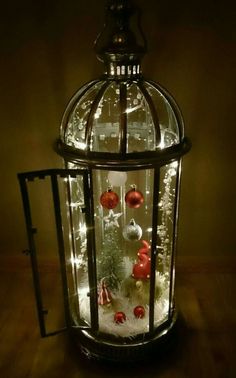 a lighted lantern with ornaments in it