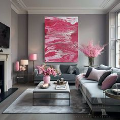 a living room filled with lots of furniture and pink flowers in vases on the coffee table