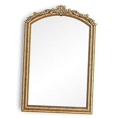 an ornate gold framed mirror on a white wall