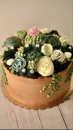 a cake decorated with flowers on top of a wooden table