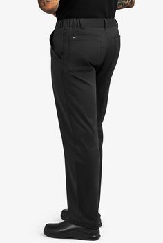 A trim fit and thoughtful details like belt loops give our Men's Slim Executive Chef Pants a professional look. The side-elastic waist feels great. 4 pockets. UA CHEF™ pants let you cook up your own style in comfortable, durable all-cotton fabric. Note: Pants run true to size. If you prefer a more relaxed fit, please size up. • Modern fit • Side-elastic waist with button closure • Zip fly • Slim leg • Total of 4 pockets • 2 front pockets • 2 back patch pockets • Belt loops • Approximate inseam o Business Trousers With Side Pockets, Functional Fitted Pants With Pockets, Fitted Black Bottoms With Functional Pockets, Fitted Pants With Functional Pockets And Tapered Leg, Functional Trousers With Hip Pockets, Fitted Black Pants With Functional Pockets, Functional Fitted Tapered Leg Bottoms, Functional Tapered Leg Cargo Pants, Fitted Functional Bottoms With Tapered Leg