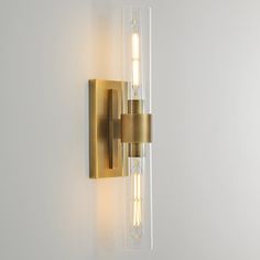 a wall mounted light with two lights on it's side and one light in the middle