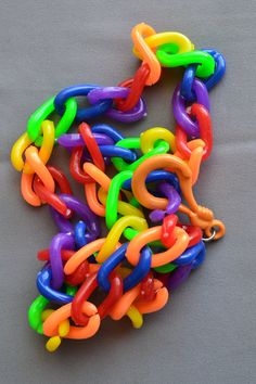 "This listing is for one vintage 1980s plastic rainbow necklace as shown. Add your own vintage charms or wear as is. This is a 24\" long plastic chain link necklace with large chunky links for hanging charms. Bright colorful rainbow colors including neon green and orange links. These are chunkier with wider links than some of the old 80s charm necklaces, shown next to a ruler for scale. Charms with a very small clasp will probably not fit over the links. The fastener will move a little to the si Fun Multicolor Plastic Necklace, Multicolor Plastic Chain Jewelry, Fun Rainbow Plastic Jewelry, Hanging Charms, 80s Jewelry, Hanging Bell, Rainbow Jewelry, Rainbow Necklace, Charm Necklaces