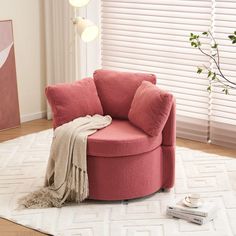 a pink chair sitting on top of a white rug