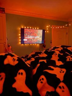 a room filled with lots of black and white stuffed animals in front of a tv