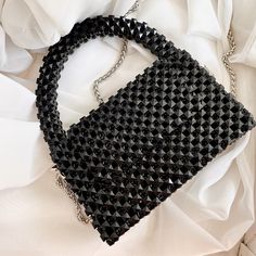 A universal bag made of black cube-shaped stones will be a great addition and highlight of your image. It looks good both with everyday clothes and with an elegant evening dress It is suitable for carrying personal items such as your mobile phone, wallet, keys, lipstick, antiseptic and notebook comfortably.  Material: Crystal Cube Beats  100% handmade  Size: Width: (22,5cm.) Height: (19cm.) Depth: (7 cm.)  The set includes a cast chain of 1 m Repeat possible in any color Carefully crafted by mas Black Square Mobile Phone Shoulder Bag, Black Square Bag For Mobile Phone, Trendy Black Handheld Box Bag, Trendy Handheld Black Box Bag, Black Rectangular Shoulder Bag, Black Square Mobile Phone Bag, Beaded Top Handle Evening Shoulder Bag, Beaded Top Handle Shoulder Bag For Evening, Evening Top Handle Bag With Beaded Details