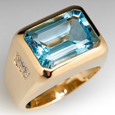 This bold and beautiful ring is centered with one (1) bezel set emerald cut natural topaz. The shoulders of the ring are each accented with six (6) bead set round brilliant cut diamonds. The ring measures 13.5mm at the top, rises 8.1mm above the finger, and tapers to 6.3mm wide by 1.9mm thick at the base of the shank.  It is currently a size 8.25. Luxury Gemstones With Bezel Setting For Formal Occasions, Luxury Bezel Set Gemstones For Formal Occasions, Luxury Formal Gemstones With Bezel Setting, Modern Topaz Ring With Brilliant Cut For Formal Occasions, Luxury Topaz Ring Emerald Cut With Vvs Clarity, Luxury Emerald-cut Topaz Ring With Vvs Clarity, Luxury Baguette-cut Topaz Ring, Modern 14k Gold Emerald Cut Topaz Ring, Modern Topaz Ring With Diamond Accents For Formal Events