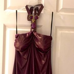 a purple dress hanging on a door handle