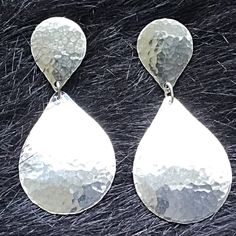 These stunning hammered silver drop earrings will give an elegant edge to any essemble!  These are Post Earrings with the top drop measuring just under .75 inches and the bottom 1.25 inches for a total of 2 inches in length. The largest drop is 7/8 inches wide. These beauties would make a much appreciated gift and are especially handmade for you in my studio!So I am thinking of posting this in a picture. CANADA - GST/HST included in prices.  Provincial tax, where applicable, is added at checkout Hammered Teardrop Earrings For Formal Occasions, Elegant Hammered Dangle Teardrop Earrings, Elegant Hammered Teardrop Dangle Earrings, Hammered Teardrop Earrings For Anniversary, Silver Hammered Teardrop Dangle Earrings, Elegant Hammered Sterling Silver Teardrop Earrings, Elegant Silver Hammered Earrings, Silver Hammered Teardrop Earrings, Silver Hammered Drop Earrings