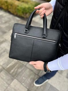 Laptop Bag "Collide", Luxury Leather Briefcase, Black Messenger Bag, Men's Traveling Port, Slim Rucksack, Notebook Bag, Laptop Case, Satchel ∎ Material: genuine leather ∎ A strap is included ∎ 2 main departments ∎ 1 additional department ∎ 1 zipped pocket in the middle ∎ 1 Compartment inside for laptop/things ∎ Additional 2 small pockets inside ∎ Height: 30 cm / 11.8 in, ∎ Length: 38.5 cm / 15.2 in, ∎ Width: 6 cm / 2.4 in This handmade genuine leather bag is made from traditional leather. The ba Black Backpack With Adjustable Strap For Business Trips, Black Rectangular Backpack With Top Carry Handle, Black Briefcase With Adjustable Strap And Backpack Shape, Black Briefcase Backpack With Adjustable Strap, Black Briefcase With Adjustable Strap, Black Rectangular Office Backpack, Black Business Backpack Satchel, Modern Black Top Handle Backpack, Everyday Black Laptop Bag