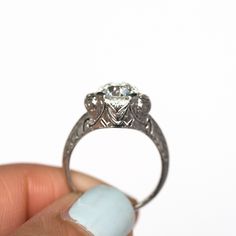 * VIEW A VIDEO OF THIS RING * https://youtu.be/BRM1AzajQQc Description: Here is a beautiful antique engagement ring, with a classic style that will last a lifetime. The center diamond is a gem indeed. It is a GIA certified 1.64ct Old European Brilliant Cut, with a warm H color and SI2 clarity. This high quality gem has amazing fire and brilliance at all angles, and we really enjoy rocking it back and forth to see the scintillation in the piece. The center diamond is surrounded by .06cttw antique Heirloom Asscher Cut Ring With Center Stone, Gia Certified Art Deco White Gold Rings, Gia Certified Heirloom Diamond Ring As Gift, Gia Certified Art Deco Rings, Heirloom Diamond Cut Cluster Ring For Promise Occasion, Heirloom Gia Certified Diamond Ring Gift, Heirloom Asscher Cut Gia Certified Diamond Ring, Heirloom Heart Cut Jewelry With Vvs Clarity, Gia Certified 14k White Gold Art Deco Ring