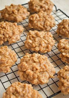 several cookies cooling on a wire rack with some oatmeal in the middle