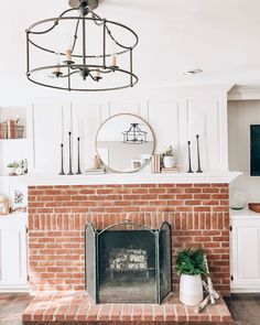 a living room with a fire place and a mirror on the wall above it's mantle