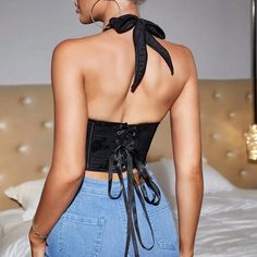 Make a bold statement with our black floral embroidered corset top, designed with a captivating halter neck. The artistic embroidery adds a feminine touch, while the lace-up back detail brings in a modern twist. This top offers both comfort and flexibility, ideal for any occasion where you want to turn heads. Wear it solo with high-waisted pants or layer it under a blazer for a polished look. Elevate your fashion game with this uniquely stylish piece. Color: BlackNeckline: HalterSilhouette: Shea Fitted Crop Top With Lace-up Back For Party, Black Lace-up Back Corset For Night Out, Lace-up Backless Top, Spring Lace-up Backless Top, Sleeveless Lace-up Back Top For Party, Backless Lace-up Back Top For Spring, Fitted Lace-up Back Top For Party, Sleeveless Party Top With Lace-up Back, Sleeveless Lace-up Back Top For Night Out