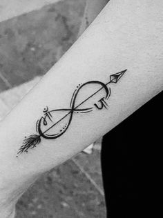 a person with a tattoo on their arm that has an arrow in the middle of it